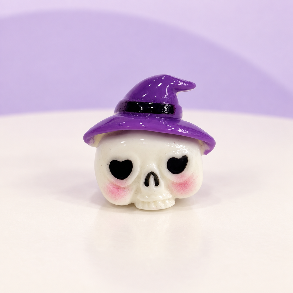White skull dog collar charm with a purple witch hat and heart-shaped eyes for Halloween