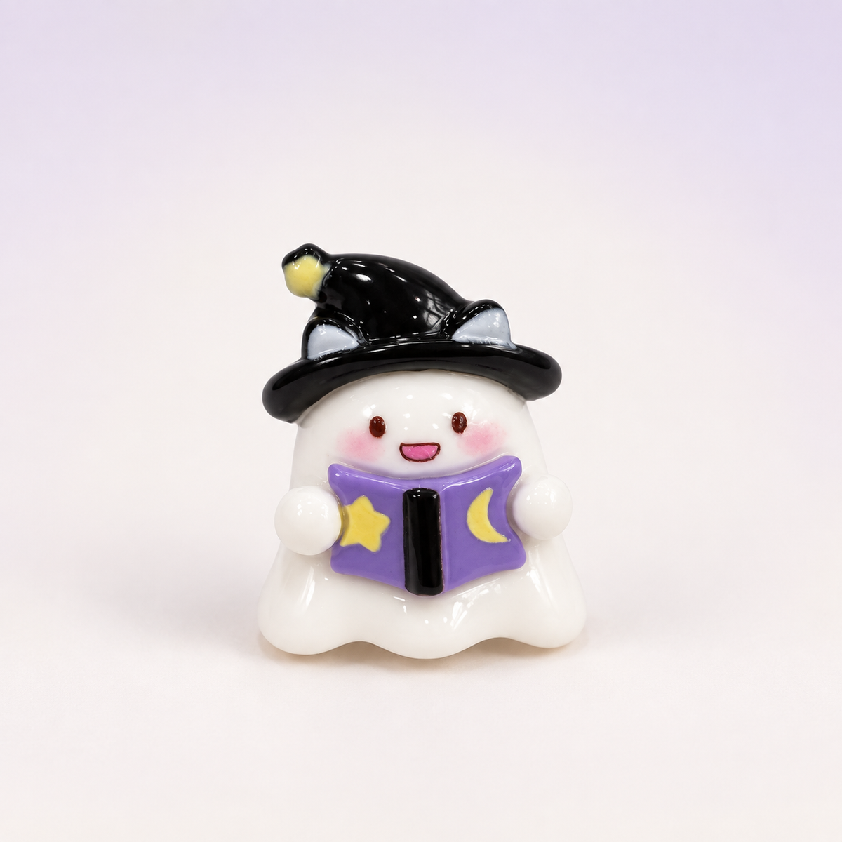 White ghost dog collar charm wearing a black witch hat and holding a purple spell book for Halloween