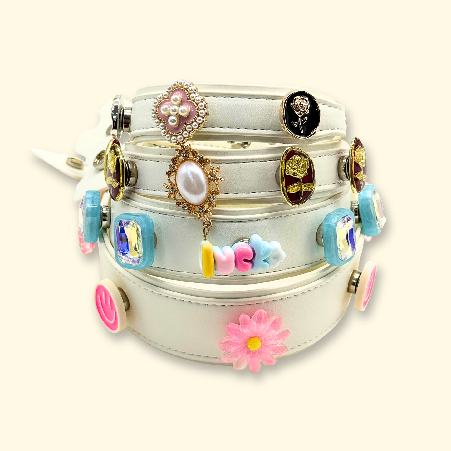 White interchangeable dog collar styled with mix-and-match pet charms including pearl, floral, rhinestone, and kawaii accessories